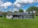 Side exterior view of a home that features an enclosed screened-in pool at 3952 Laurel Branch Dr, Lakeland, FL 33810