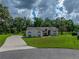 Charming single-story home featuring a well-manicured lawn and a long driveway at 3952 Laurel Branch Dr, Lakeland, FL 33810