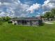 Manicured lawn with an enclosed pool on the exterior side of this home at 3952 Laurel Branch Dr, Lakeland, FL 33810
