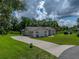 Single-story home with a side-entry garage and screened lanai, set on a lush green lawn at 3952 Laurel Branch Dr, Lakeland, FL 33810