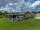 An exterior side view showing the screened in pool and deck area of the property at 3952 Laurel Branch Dr, Lakeland, FL 33810