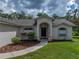 Close-up of the front entrance with a decorative walkway, arched entryway and well-kept landscaping at 3952 Laurel Branch Dr, Lakeland, FL 33810