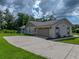 Spacious two-car garage with decorative windows and a long driveway at 3952 Laurel Branch Dr, Lakeland, FL 33810