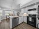 Bright eat-in kitchen featuring an island with sink, stainless steel appliances, and updated cabinetry at 3952 Laurel Branch Dr, Lakeland, FL 33810