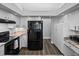 Bright kitchen features white cabinets, modern appliances, granite countertops, and wood-look floors at 3952 Laurel Branch Dr, Lakeland, FL 33810