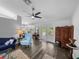 Bright living room features hardwood floors, a ceiling fan, and access to the outdoor living space at 3952 Laurel Branch Dr, Lakeland, FL 33810