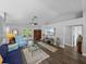 Spacious living room featuring dark floors, neutral walls, and natural light from patio doors at 3952 Laurel Branch Dr, Lakeland, FL 33810