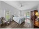 Bright main bedroom with pool view, vaulted ceiling, fan, wood floors, and light colored bed at 3952 Laurel Branch Dr, Lakeland, FL 33810