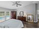 Bright main bedroom with pool view, vaulted ceiling, fan, wood floors, and dark furniture at 3952 Laurel Branch Dr, Lakeland, FL 33810