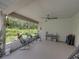 Relaxing screened lanai with comfortable seating, a ceiling fan, and a lush garden view at 3952 Laurel Branch Dr, Lakeland, FL 33810