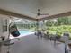This screen enclosed lanai has comfortable seating and an overhead view of the pool at 3952 Laurel Branch Dr, Lakeland, FL 33810