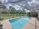 Serene screened-in pool area surrounded by greenery, perfect for relaxation and recreation at 3952 Laurel Branch Dr, Lakeland, FL 33810