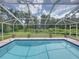 Screened in pool with blue tile trim and several potted plants along the perimeter at 3952 Laurel Branch Dr, Lakeland, FL 33810