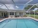 Refreshing screened-in pool featuring stairs, patio seating and access to the house at 3952 Laurel Branch Dr, Lakeland, FL 33810