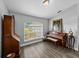 Cozy room boasts natural light from the window, complemented by wood floors and beautiful furnishings at 3952 Laurel Branch Dr, Lakeland, FL 33810