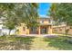 Backyard featuring an expansive lawn, a patio, and mature trees at 1769 Strathmore Cir, Mount Dora, FL 32757