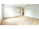 This is a bright bedroom with a large closet and neutral carpet flooring, offering storage and comfort at 1769 Strathmore Cir, Mount Dora, FL 32757