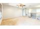 Spacious bonus room area with ceiling fan, neutral carpet, staircase, and natural light from windows at 1769 Strathmore Cir, Mount Dora, FL 32757