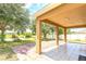 Inviting covered patio overlooking a picturesque pond and backyard area at 1769 Strathmore Cir, Mount Dora, FL 32757