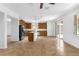 Open-concept kitchen with dark wood cabinetry, stainless steel appliances, a breakfast bar, and sliding glass doors at 1769 Strathmore Cir, Mount Dora, FL 32757