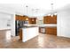 Well-lit kitchen with an island, stainless steel appliances, ample cabinet space, and tiled floors at 1769 Strathmore Cir, Mount Dora, FL 32757