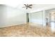 Expansive living room featuring neutral tile flooring, a ceiling fan, and views of the entryway at 1769 Strathmore Cir, Mount Dora, FL 32757