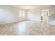 Bright and spacious living room with neutral tile flooring, ample natural light, and a view into the kitchen at 1769 Strathmore Cir, Mount Dora, FL 32757