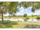 Picturesque pond view with picnic table and lush green grass at 1769 Strathmore Cir, Mount Dora, FL 32757