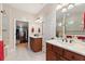 En suite bathroom with double sink vanity, a walk-in closet and shower with glass door at 224 Granada Ln, Davenport, FL 33837