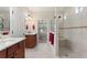 Bathroom with tiled shower, double vanity, and open doorway to bedroom at 224 Granada Ln, Davenport, FL 33837