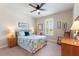 Comfortable bedroom with a paisley bed, ceiling fan, window with plantation shutters, and neutral walls at 224 Granada Ln, Davenport, FL 33837