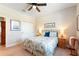 Cozy bedroom features a paisley patterned bed, ceiling fan, and soft neutral walls at 224 Granada Ln, Davenport, FL 33837