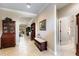 Welcoming foyer with neutral tile flooring, elegant furniture, and views into the living area at 224 Granada Ln, Davenport, FL 33837