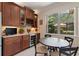Kitchen area with built in wine cooler with table in front of a large window with view to outdoors at 224 Granada Ln, Davenport, FL 33837