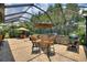 Expansive enclosed patio with outdoor kitchen, dining, and multiple seating areas at 224 Granada Ln, Davenport, FL 33837