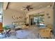 Inviting covered patio with comfortable seating, ceiling fan, and sliding glass doors to bring the outdoors in at 224 Granada Ln, Davenport, FL 33837