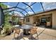 Lovely screened-in patio with seating areas and outdoor kitchen and dining at 224 Granada Ln, Davenport, FL 33837