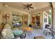 Relaxing covered patio with comfortable seating and view through sliding doors at 224 Granada Ln, Davenport, FL 33837