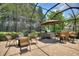 Enclosed patio with outdoor kitchen, dining table, and seating area at 224 Granada Ln, Davenport, FL 33837