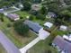 Aerial view of a home with a shed in a backyard, surrounded by a lush landscape at 3100 Peacock Ln, Mulberry, FL 33860