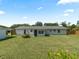 Expansive backyard featuring a well-maintained lawn, detached shed, and mature trees at 3100 Peacock Ln, Mulberry, FL 33860