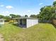 Backyard shed sits on a well-manicured lawn, great for storage and workshop space at 3100 Peacock Ln, Mulberry, FL 33860