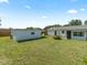 Large backyard with green grass, a shed, and a single-story home, offering outdoor space at 3100 Peacock Ln, Mulberry, FL 33860