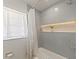 Modern bathroom with a bathtub, tiled walls, shower curtain, and lighted niche at 3100 Peacock Ln, Mulberry, FL 33860