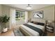 Bright bedroom featuring a large window, hardwood floors, and neutral decor, creating a peaceful atmosphere at 3100 Peacock Ln, Mulberry, FL 33860