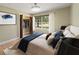 Inviting bedroom showcasing a closet, a large window offering natural light, and stylish bedding at 3100 Peacock Ln, Mulberry, FL 33860