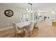 Open dining room with access to the kitchen and sunroom featuring modern lighting and hardwood floors at 3100 Peacock Ln, Mulberry, FL 33860