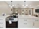 Modern kitchen with a large island, stainless steel oven, and pendant lighting open to the living room at 3100 Peacock Ln, Mulberry, FL 33860