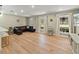Spacious living room with hardwood floors, ample natural light, and comfortable seating at 3100 Peacock Ln, Mulberry, FL 33860