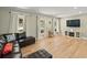 Bright living room with hardwood floors, large windows, and a cozy seating area at 3100 Peacock Ln, Mulberry, FL 33860